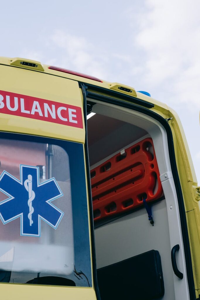 Yellow ambulance with open doors displaying medical interior equipment, emphasizing emergency response.
